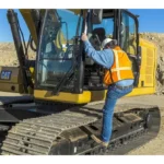 Operator entering the CAT 323 GC cab from the track