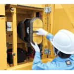 Technician changing the CAT 323 GC air intake filter