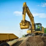 CAT 330 GC Excavator loading a Cat 772G rigid haul truck