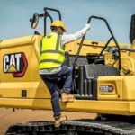 Operator climbing the CAT 330 GC access steps beside the counterweight