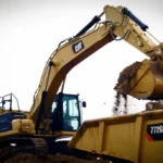 CAT 336 GC Excavator dumping a bucket into a Cat 772G haul truck