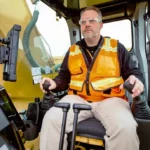 CAT 336 GC operator at the joysticks and touchscreen monitor