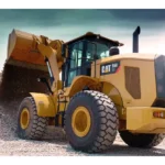 CAT 950 GC Wheel Loader dumping gravel from a raised bucket onto a stockpile