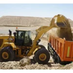 CAT 966 GC Wheel Loader loading sand into a dump truck