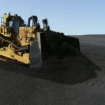 CAT D11 Bulldozer with U blade pushing coal on a stockpile