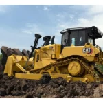 CAT D6 Bulldozer with push arm blade in loose soil, front three-quarter view
