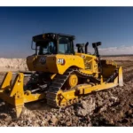 CAT D7 Bulldozer rear view with multi-shank ripper on rocky ground