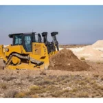 CAT D7 Bulldozer pushing a soil pile, side view