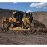 CAT D9 Bulldozer pushing broken rock on a desert site