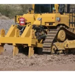 CAT D9 multi-shank ripper working rocky ground, rear close-up
