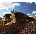 CAT D9 Bulldozer pushing a pile of blasted rock
